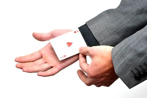 Ace card being shown coming out of jacket sleeve.