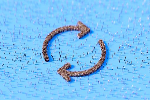 Human crowd forming circular arrow symbols on blue background.