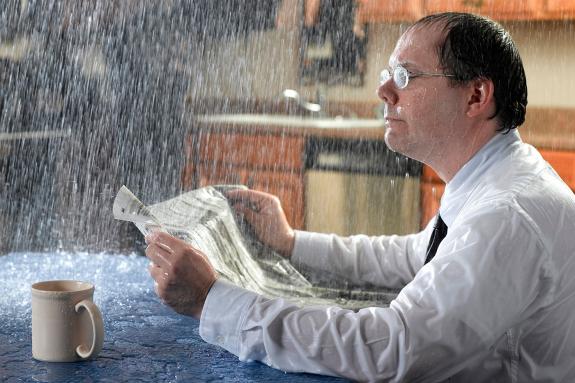 Reading newspaper in rain