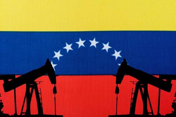 Oil pump on the background of the flag of Venezuela. Oil pump silhouette.