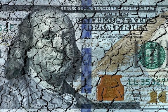 Conceptual finance image of close up damaged and dirty American one hundred dollar bill.