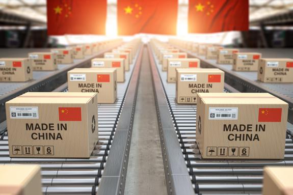 Made in China. Cardboard boxes with text made in China and Chinese flag on the roller conveyor.
