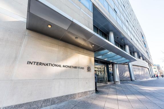 MF entrance with sign of International Monetary Fund, concrete architecture building wall security guard doors.