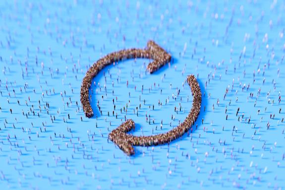 Human crowd forming circular arrow symbols on blue background.